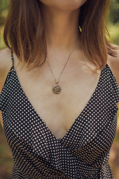 Close-up Woman a Young Woman Wearing a Dress and a Necklace 