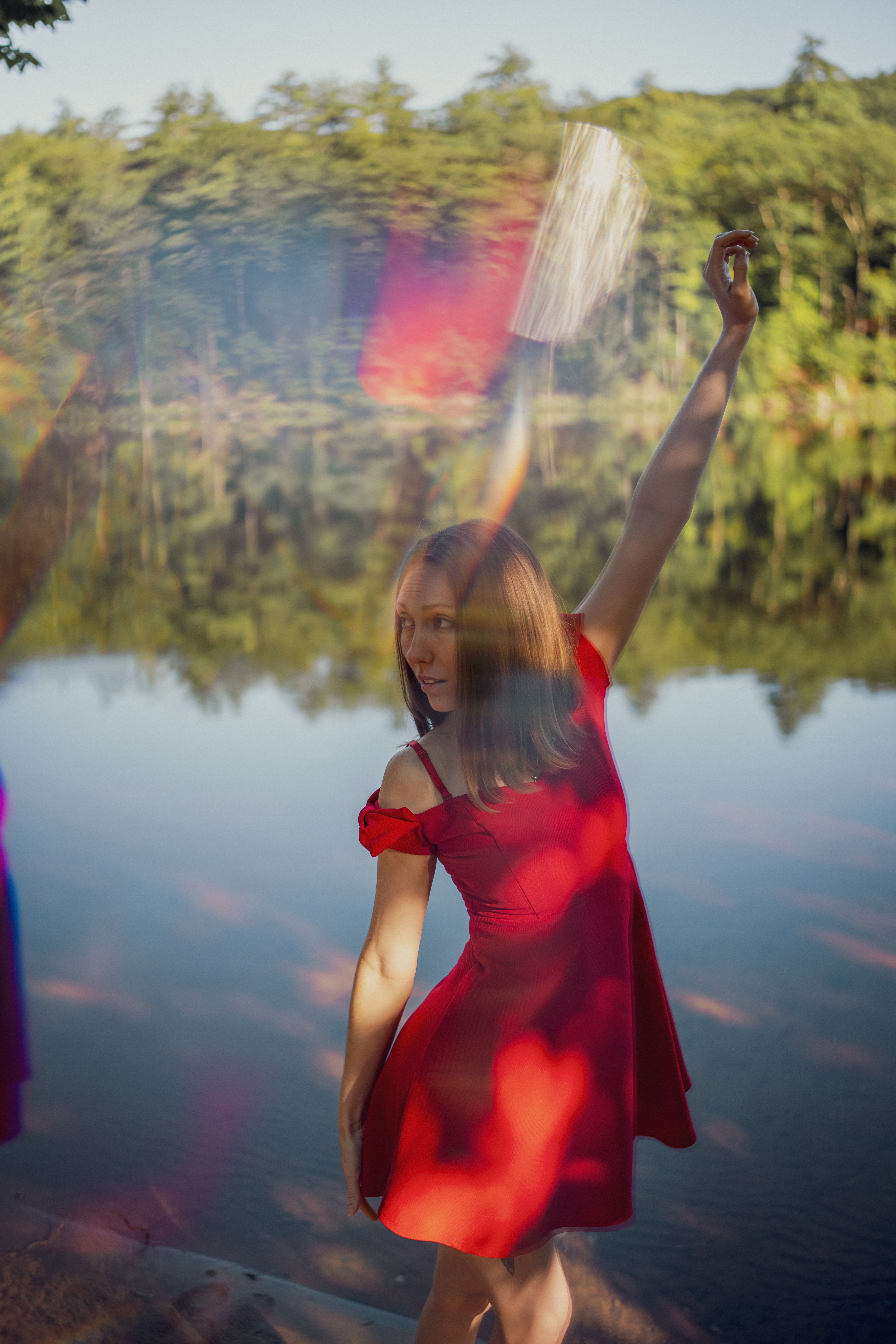 Woman in Red Sundress Standing by River  Free Stock Photo