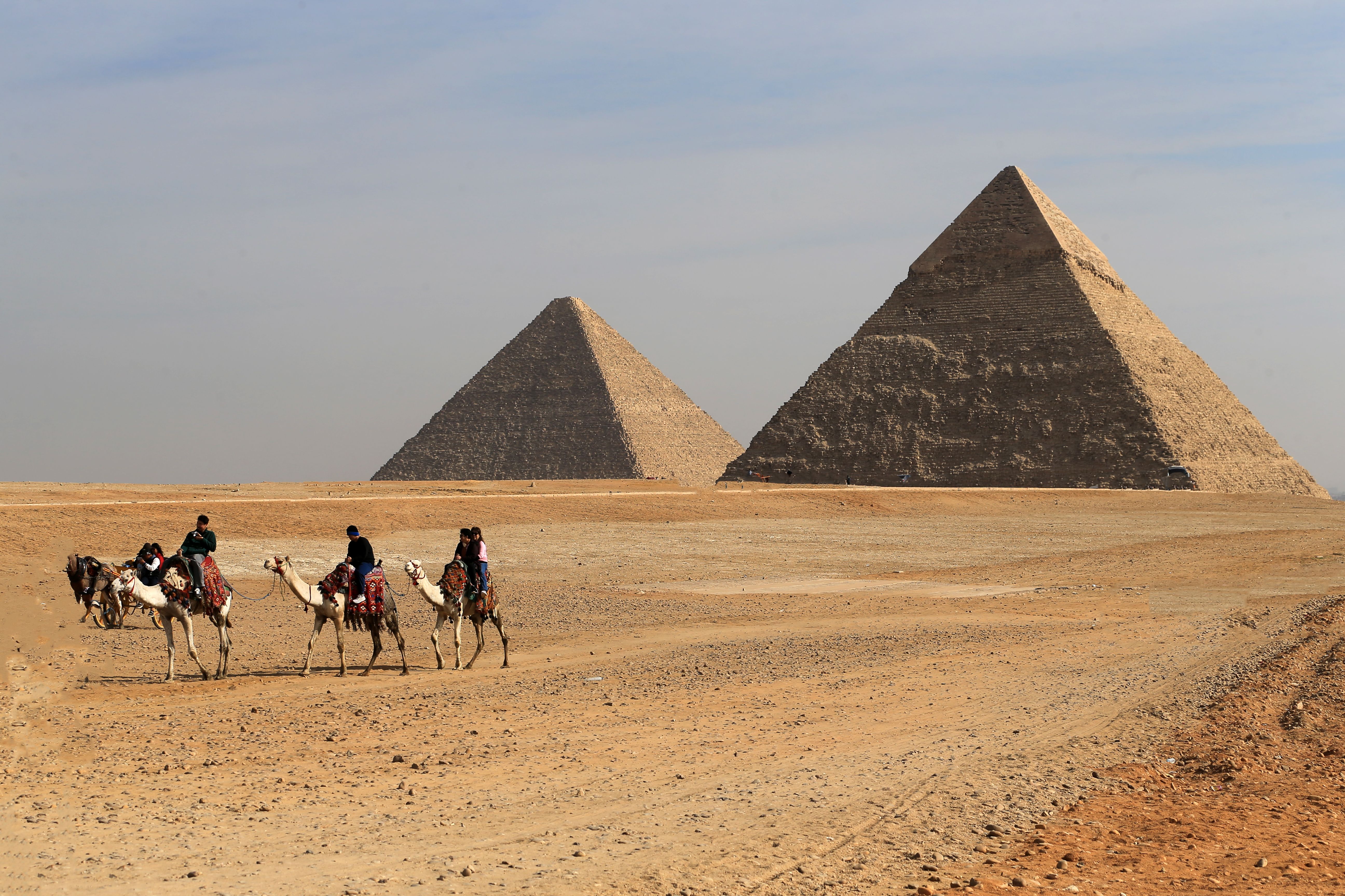 Camel riders near the pyramids of Giza — exploring Egypt with a travel buddy