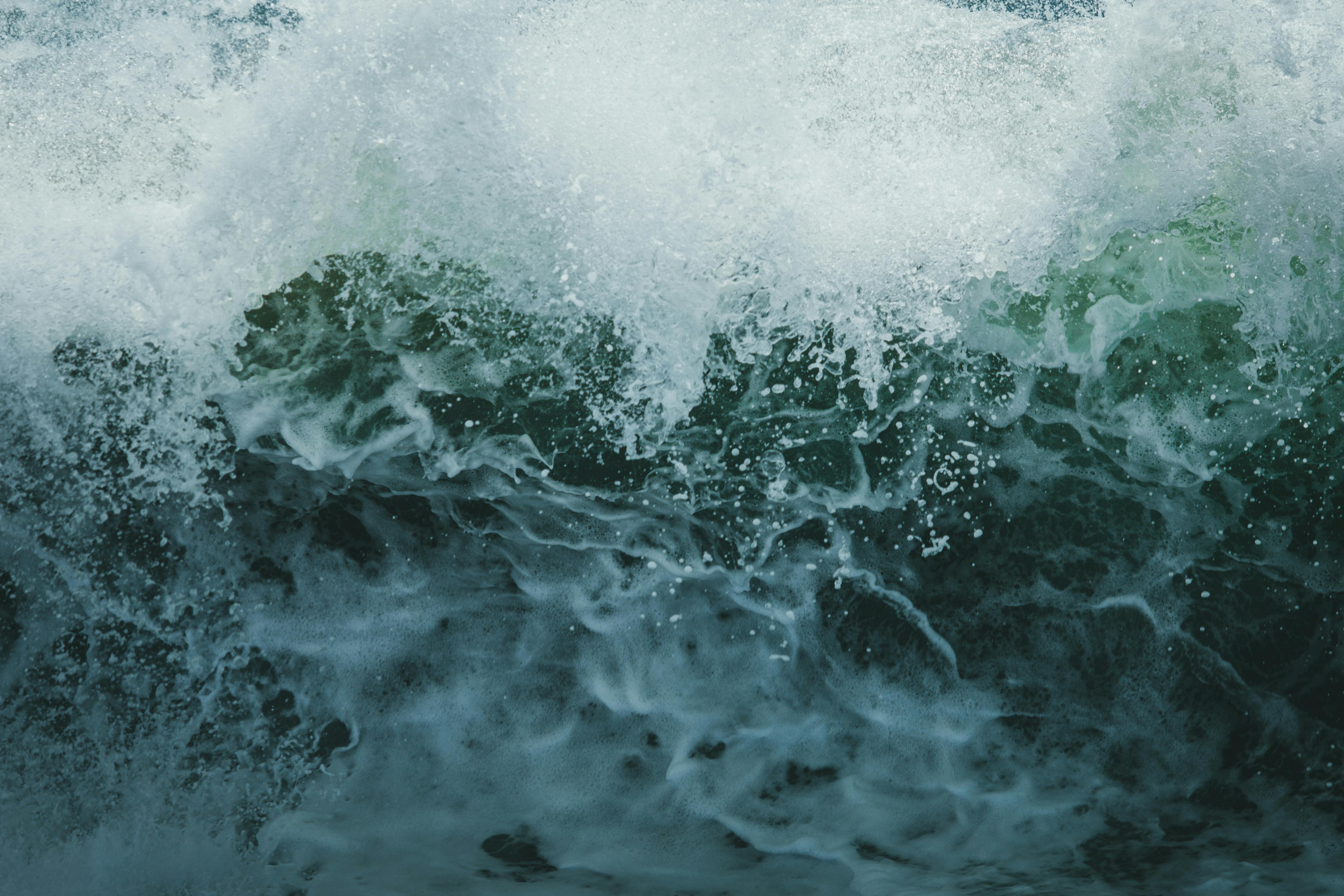 Intense capture of a powerful ocean wave crashing with a splash and foam.