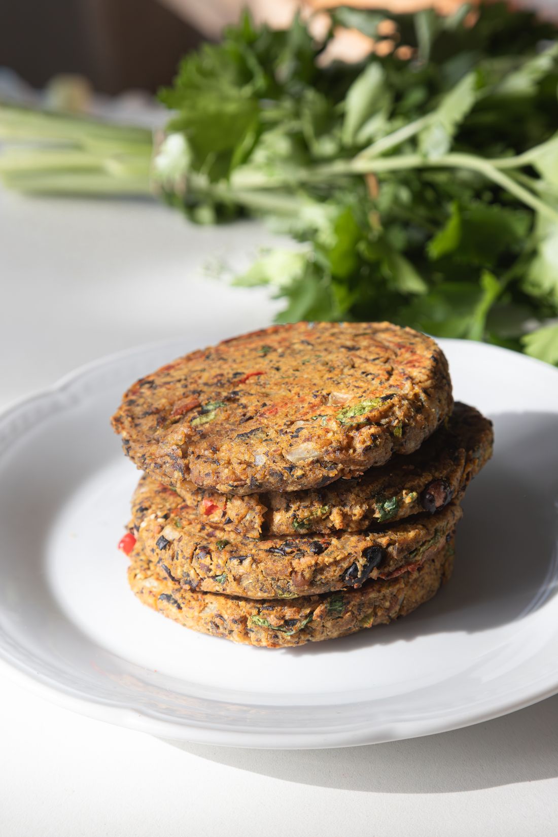A stack of plant-based patties on a plate — photo by Sofía Nuñez on Pexels