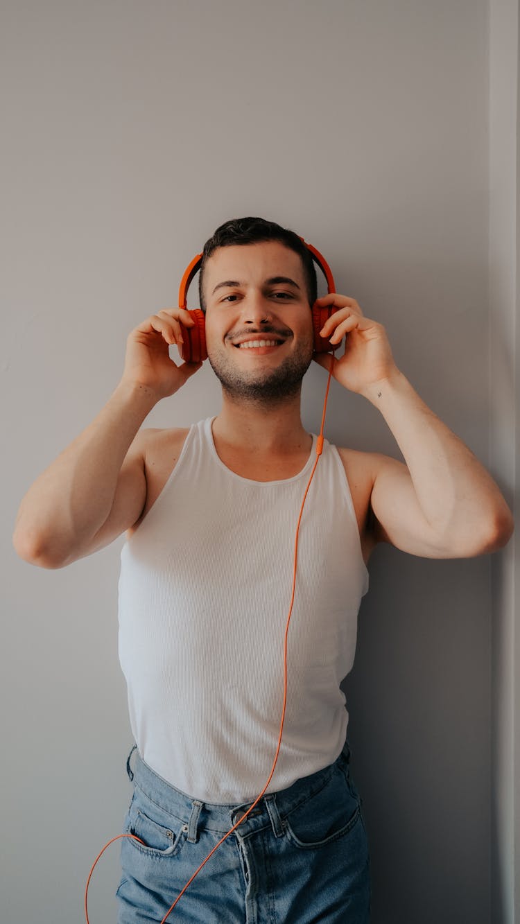 Smiling Man Holding Headphones