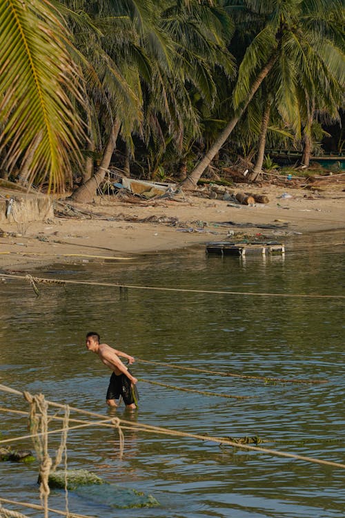 Fisherman on Tropical Sea Shore