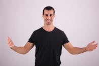 A man in black shirt with arms outstretched