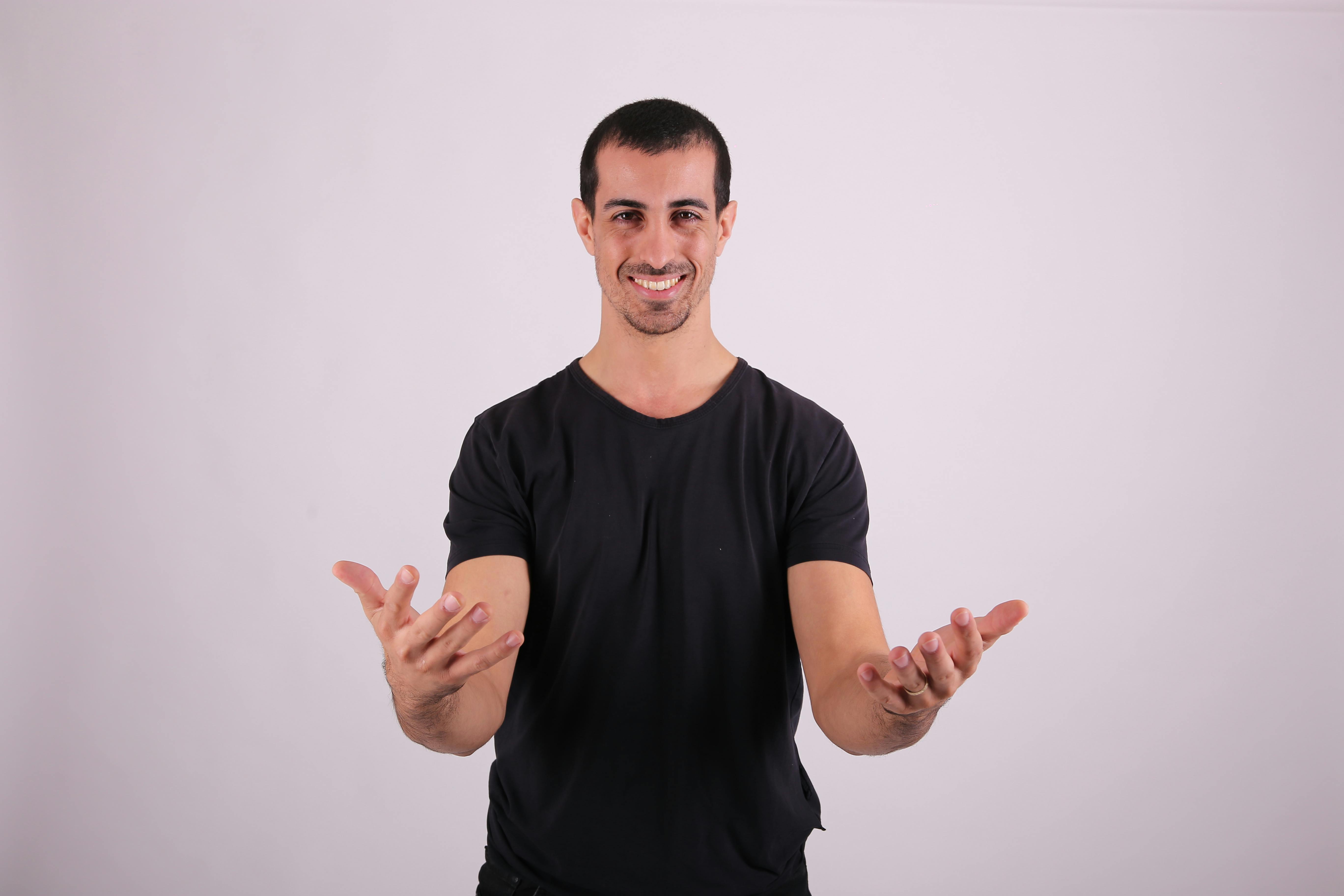 a man in black shirt is making a gesture