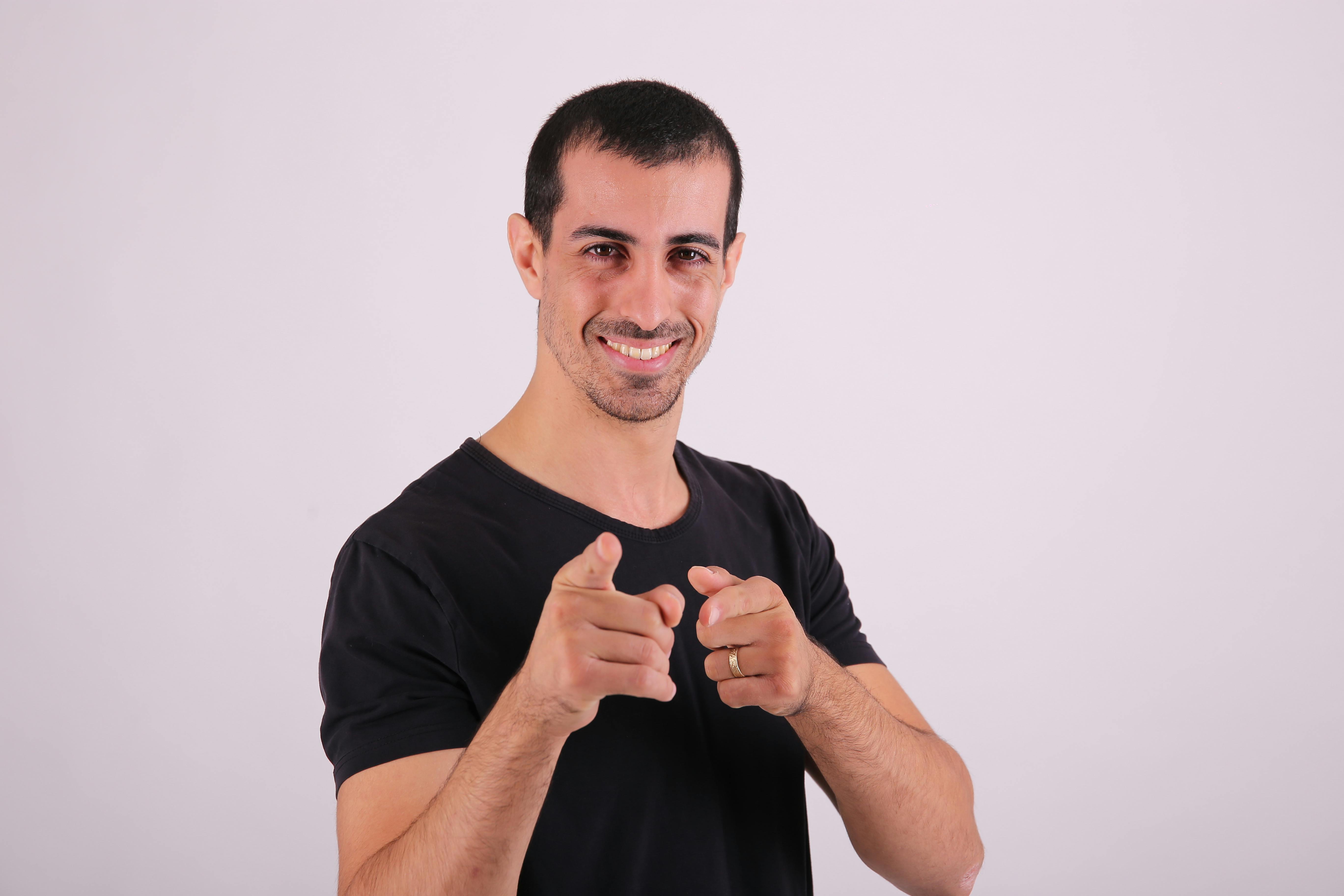 a man in black shirt pointing at something