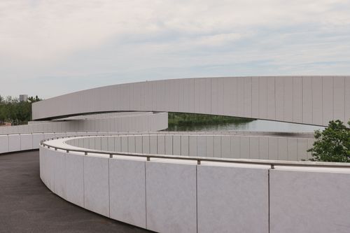 Free Curved modern footbridge with minimalist design in Nanhuixincheng Town, Shanghai. Stock Photo