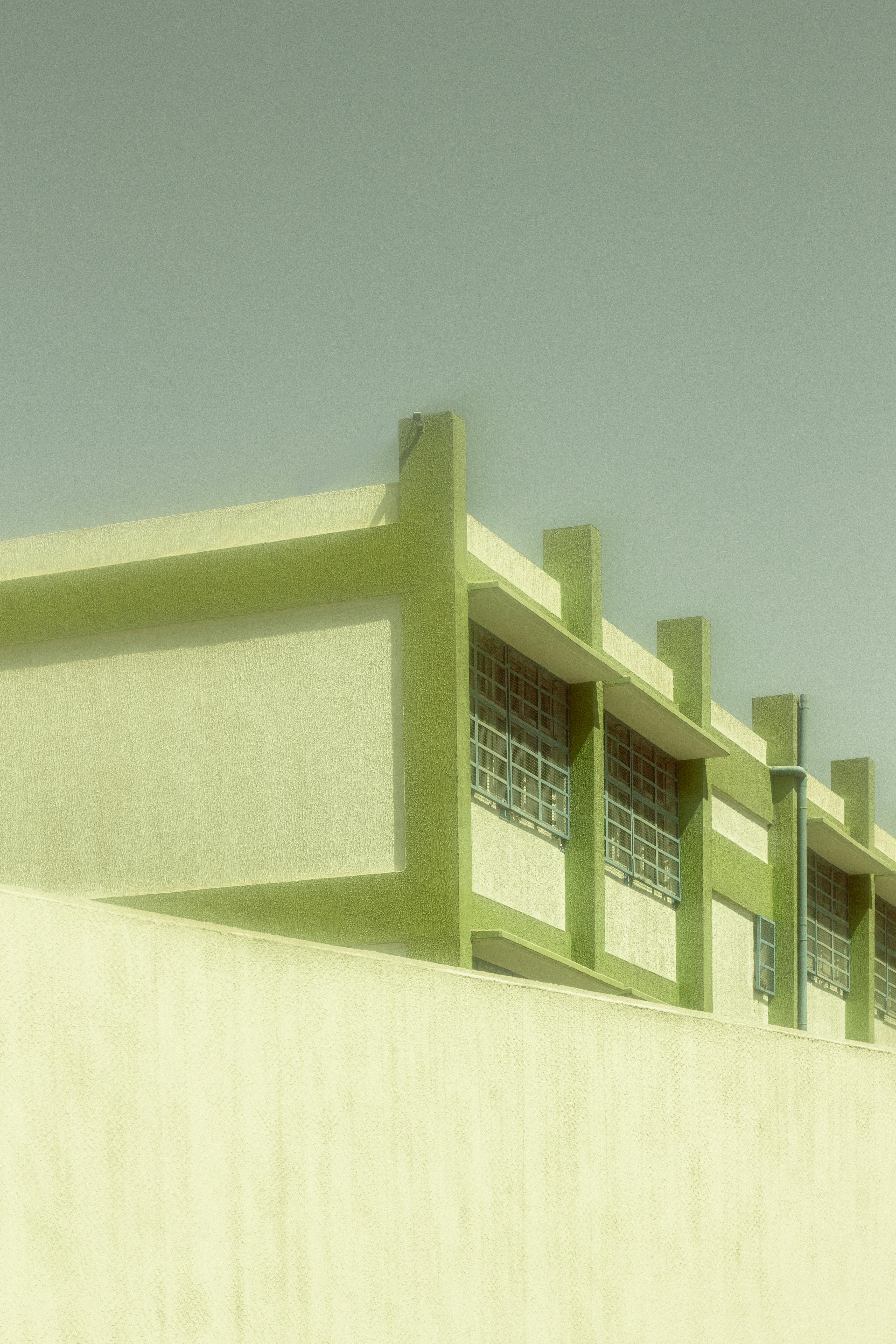 Free A modern building facade with green elements showcasing minimalist architecture. Stock Photo