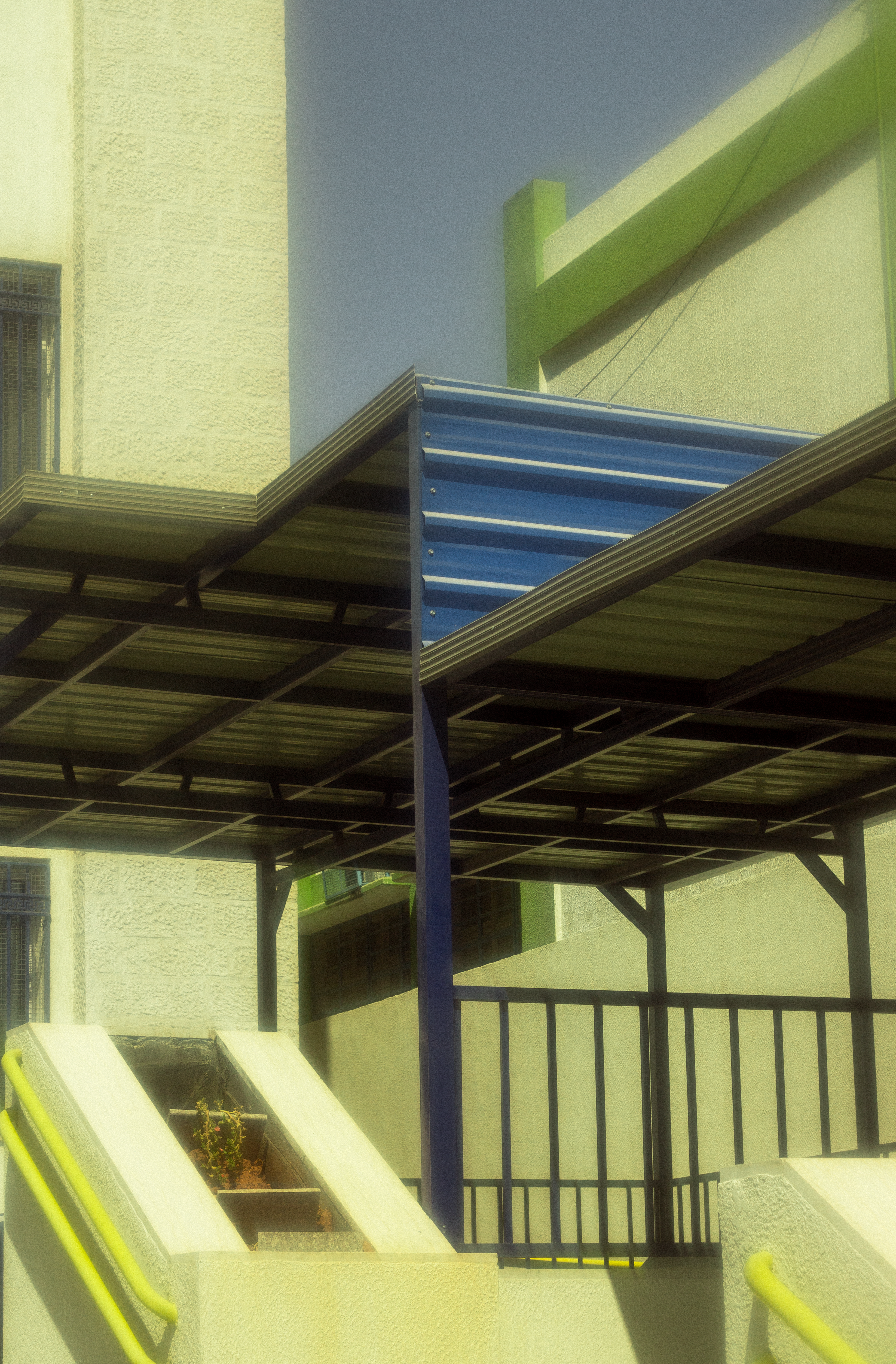 Building With Green Elements and Blue Staircase · Free Stock Photo - Green Staircase Design For High Rise Building Envelope Systems