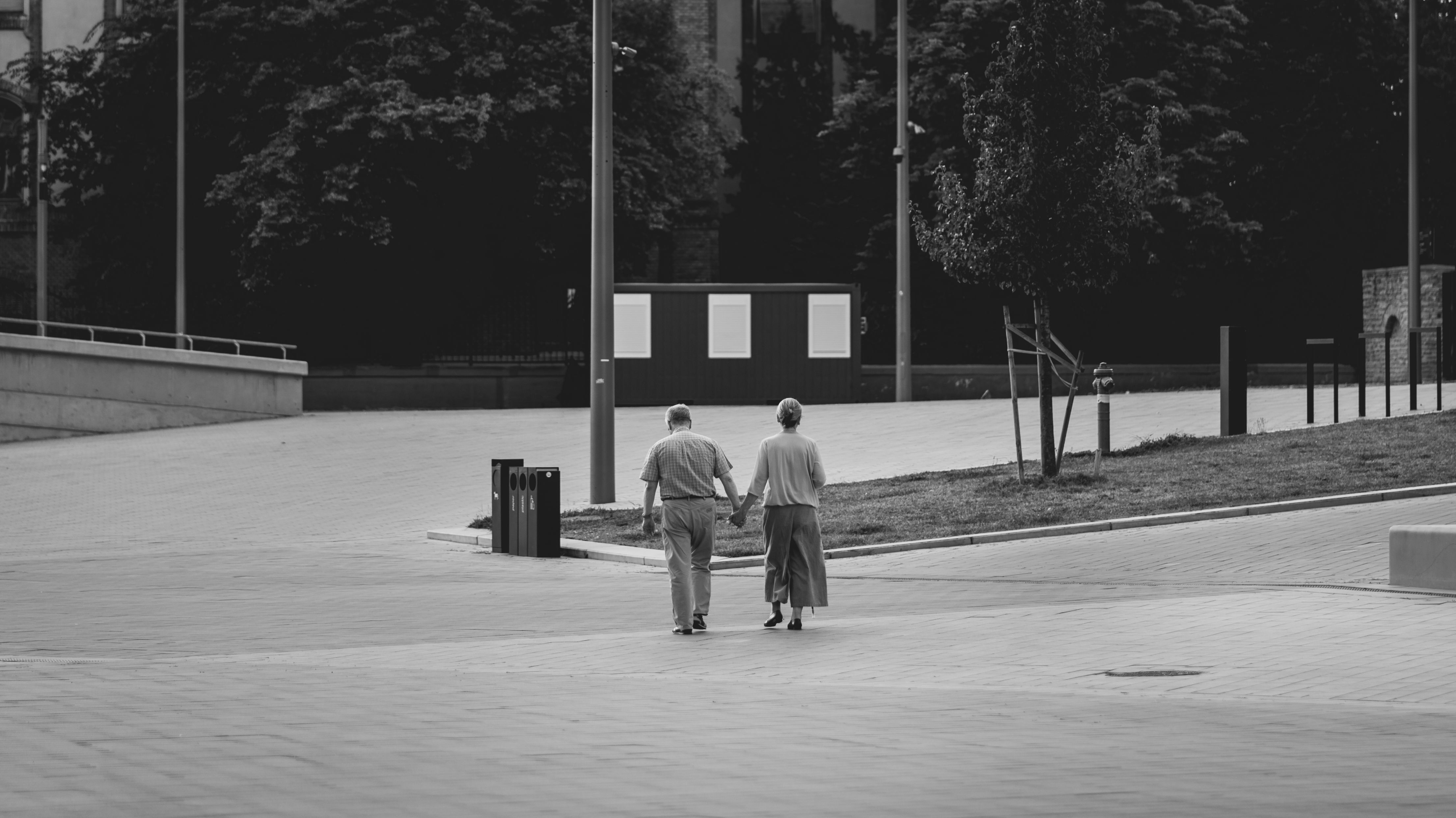 Older couple walking together on a paved park path