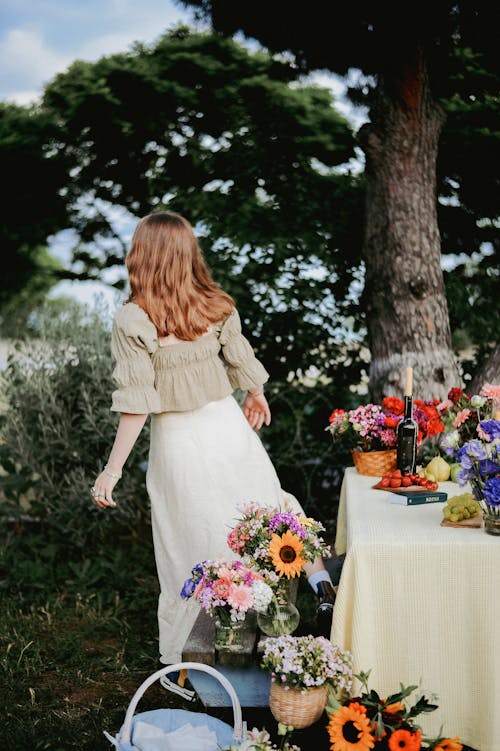 Teenager Girl Standing by a Table Decorated with Flowers