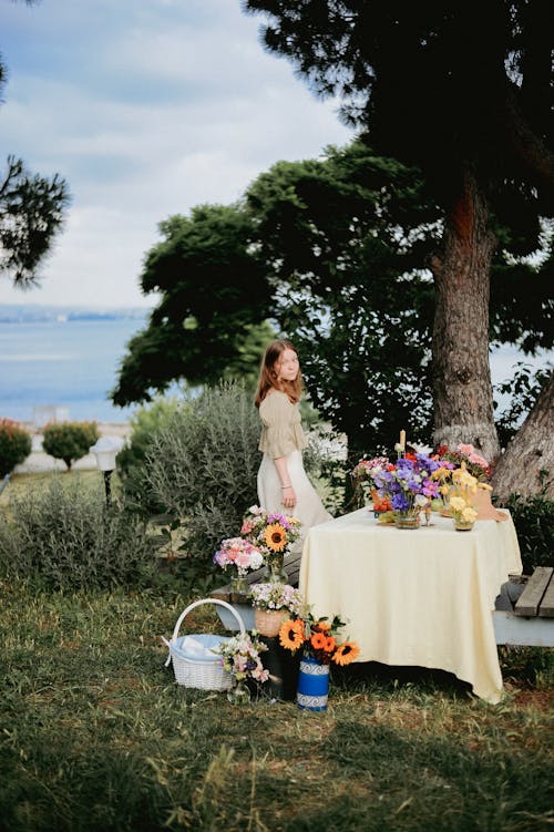 Free Little Girl Standing by the Table in Garden Stock Photo