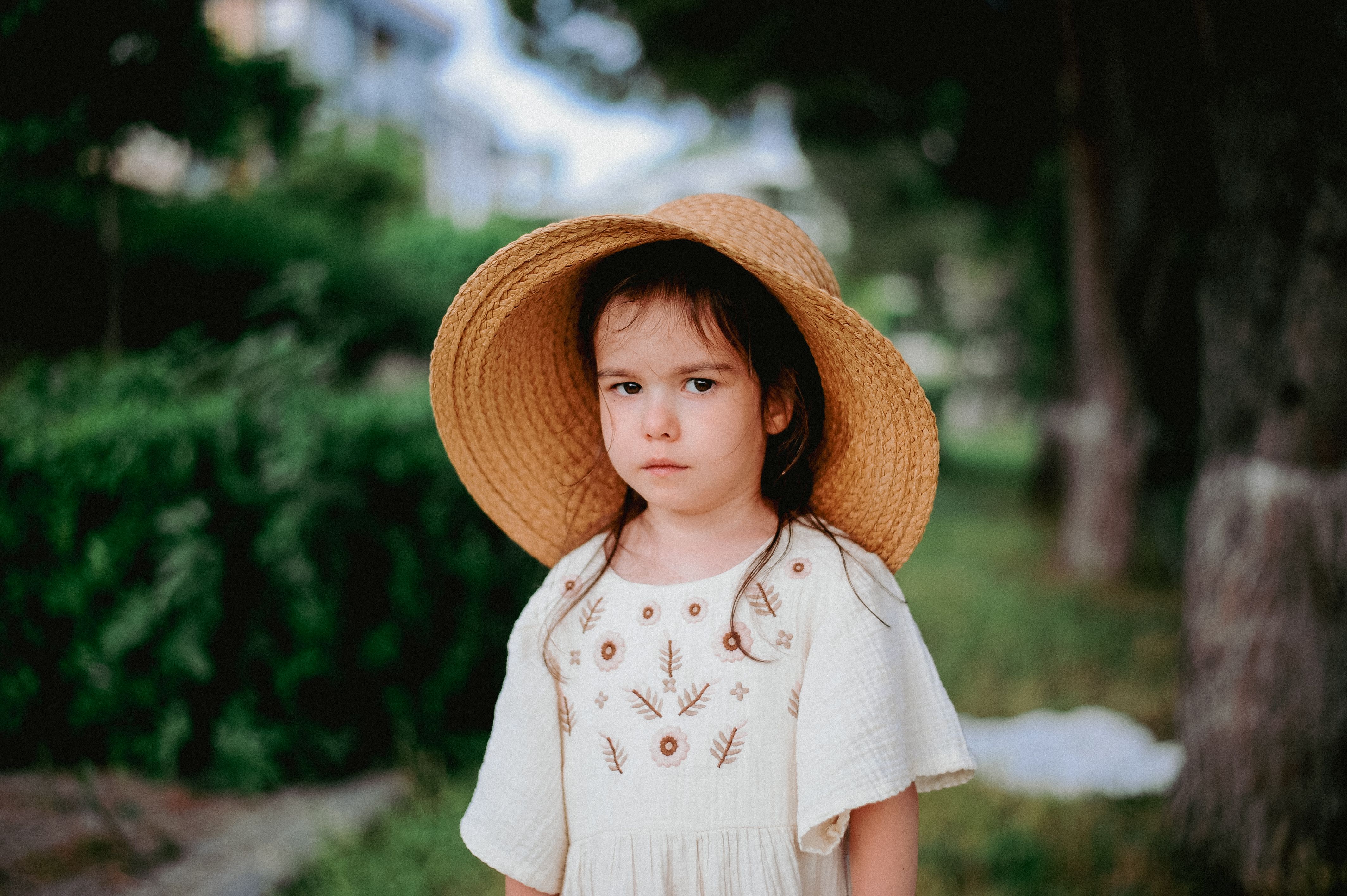 Portrait of a Little Girl in a Big Straw Hat · Free Stock Photo