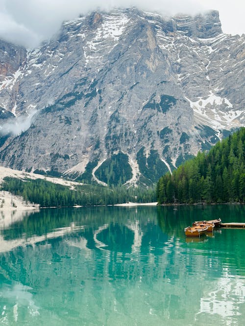 Boat at Pier at Lake in Mountains Landscape