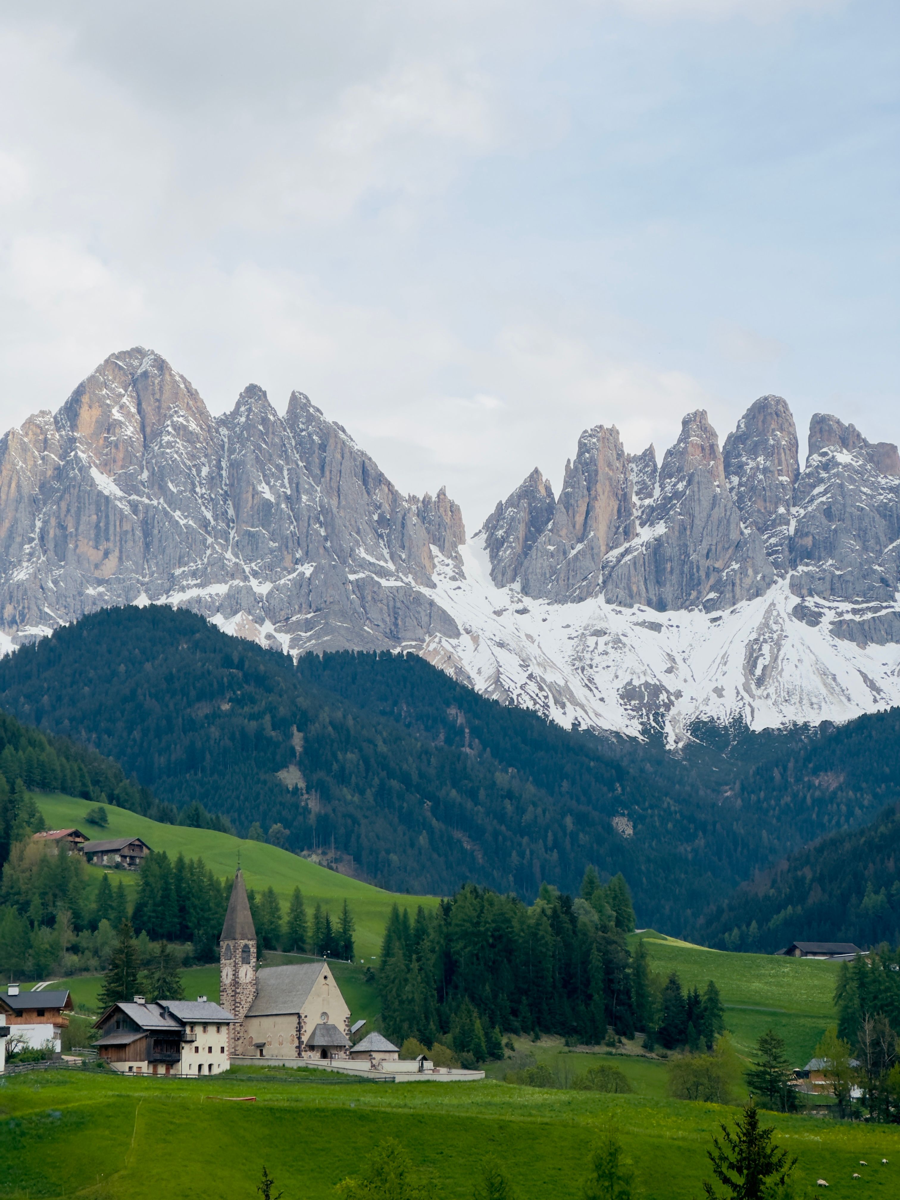 Scenic View of Snowcapped Mountains and a Village Church · Free Stock Photo