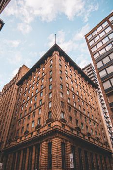 Low angle view of historic traders bank building in downtown Toronto, showcasing urban architectural beauty.