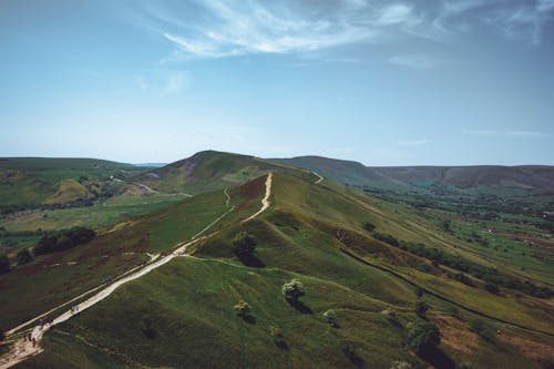 Tourists Walking on Trail in Mountains Landscape