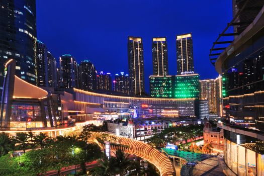Illuminated Jakarta cityscape showcasing modern skyscrapers and urban life at night.
