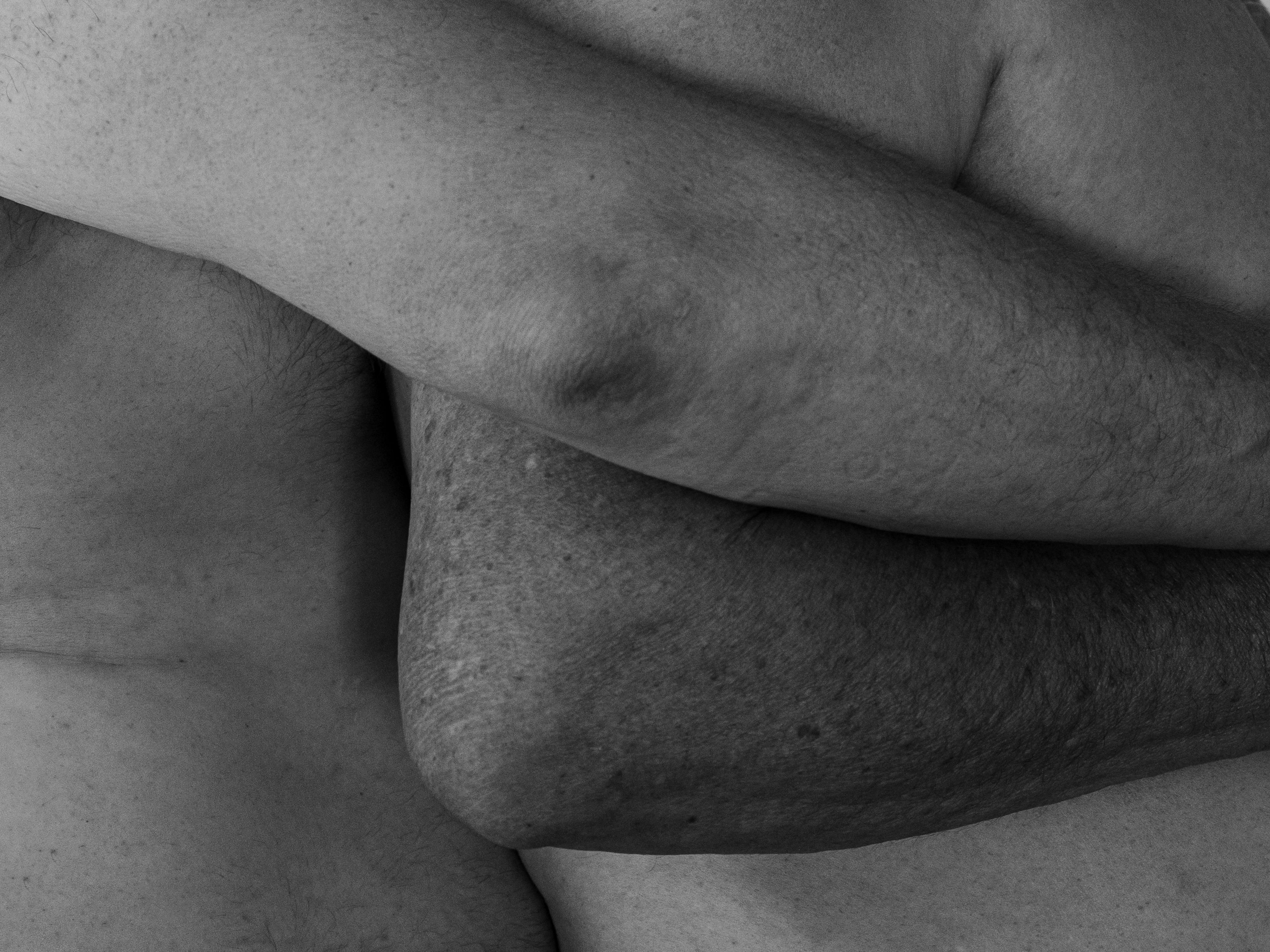 Black and white intertwined naked bodies showing deep intimacy and connection