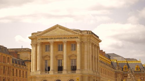 Free Majestic view of the ornate facade of Versailles, showcasing classical architectural elements and historical grandeur. Stock Photo