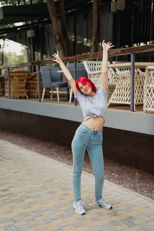 Free A Woman with her Arms Raised Stock Photo