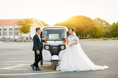 Newlyweds Standing with Auto Rickshaw on Helipad