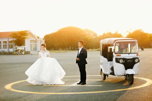 Newlyweds with Auto Rickshaw on Helipad at Sunset