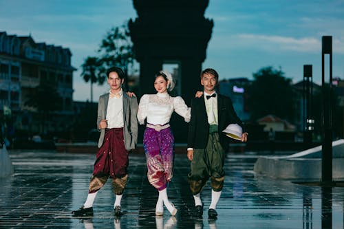 Smiling Woman and Men in Traditional Clothing