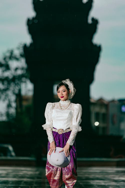 Smiling Woman Standing in Traditional Clothing