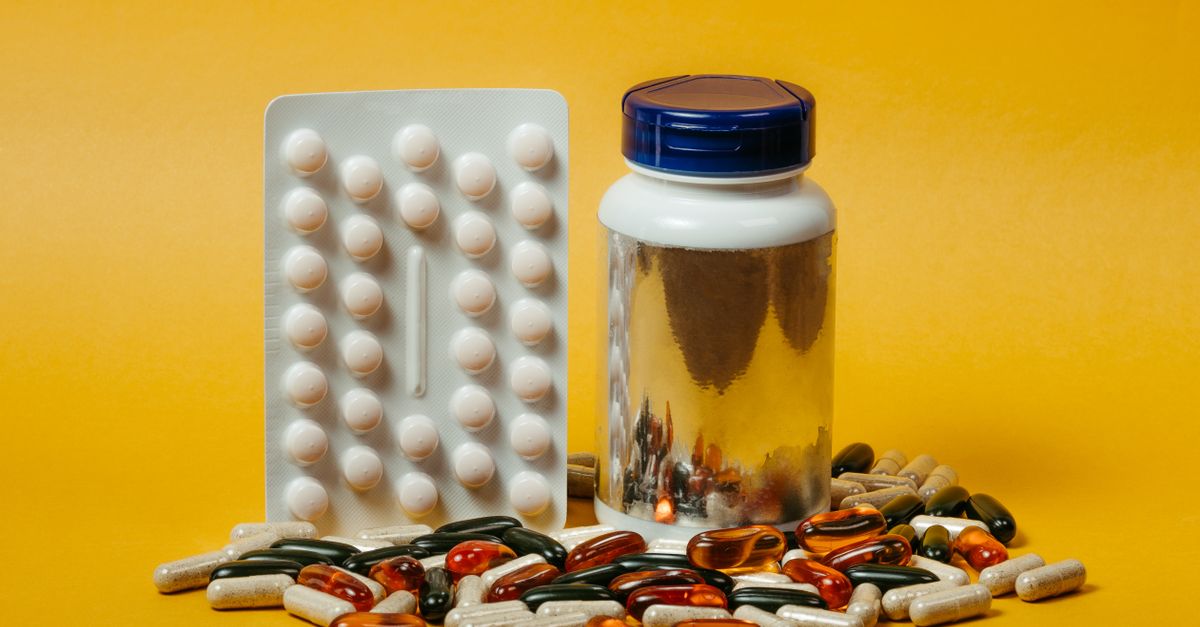 A variety of pills and capsules with a bottle on a vibrant yellow background, ideal for medical themes. - Evidence evidence guide for vitamin b9 homocysteine meta-analysis