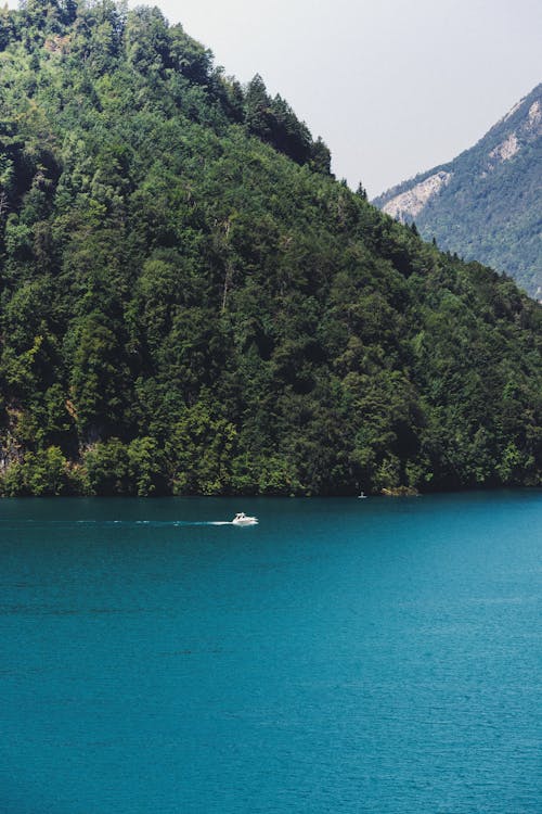 Boat in Lake in Mountains Landscape