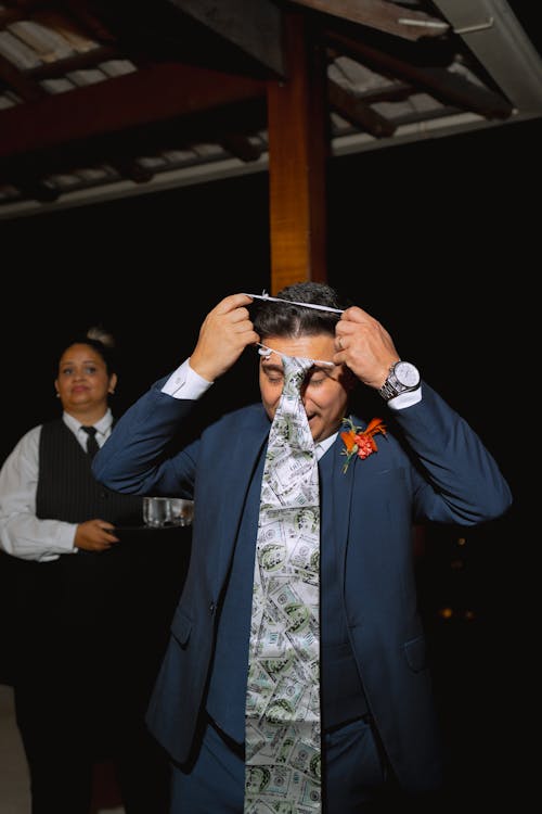A Man Putting on a Tie