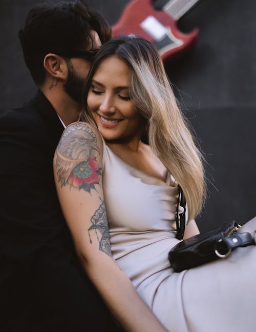 Free A Young Couple Embracing and Smiling Stock Photo