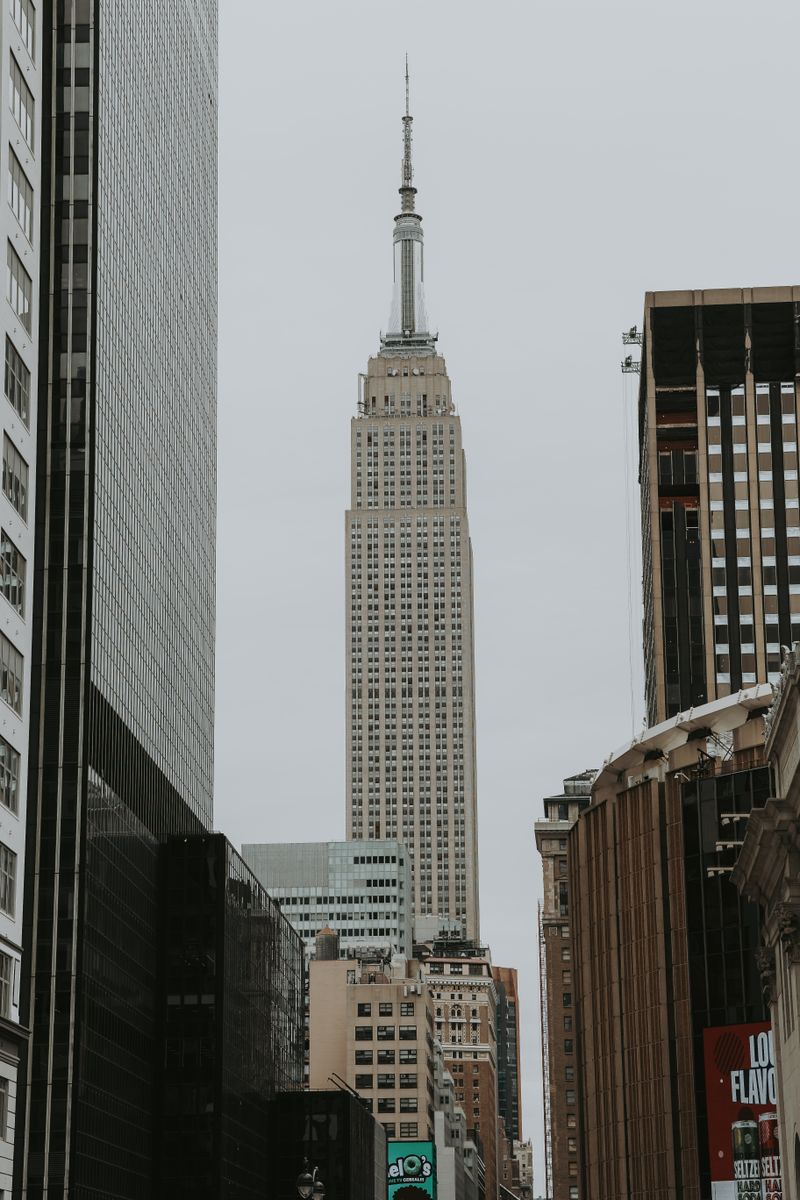The Empire State Building viewed from a Midtown street framed by other towers