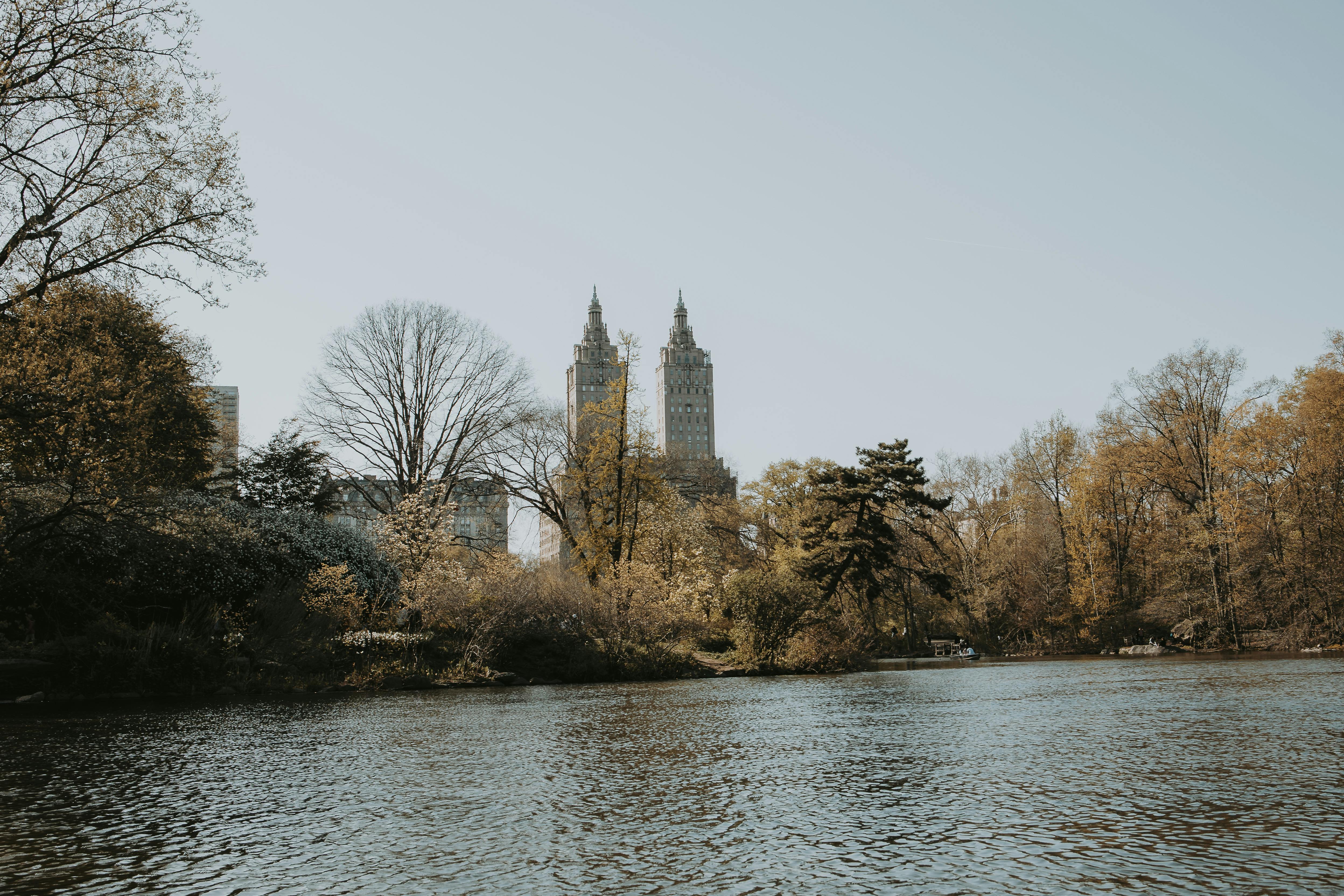 A picturesque view of Central Park with the San Remo towers in the background during fall.