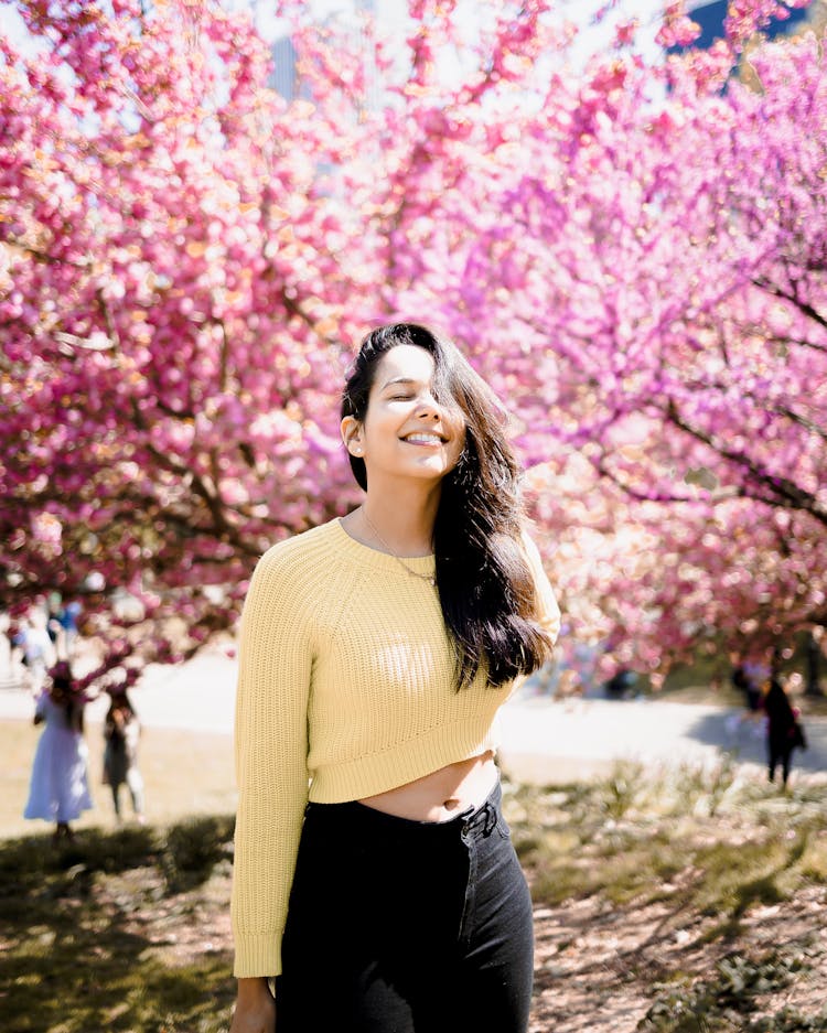 Smiling Woman With Trees In Spring Behind