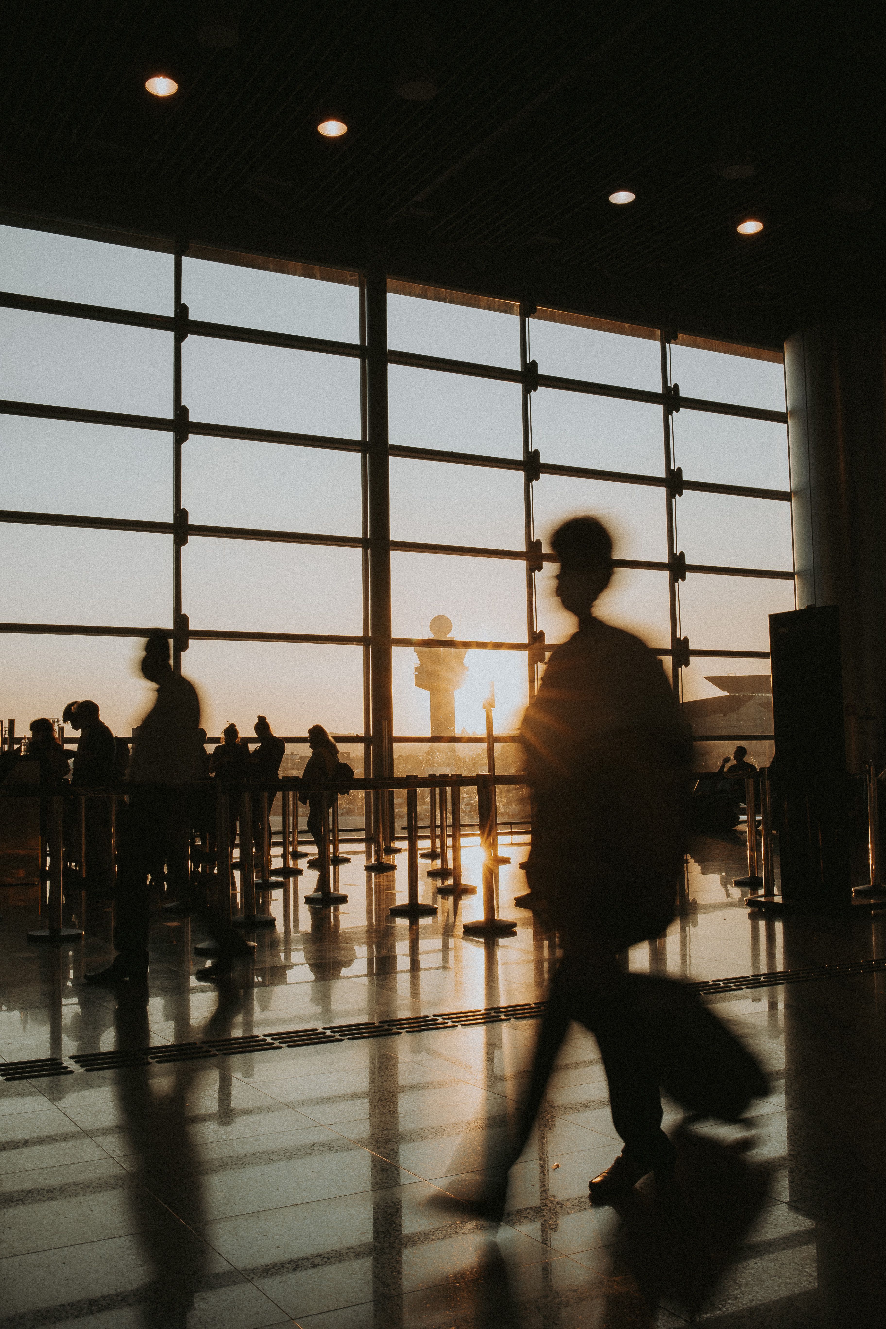 People Walking at Airport Terminal at Sunset · Free Stock Photo