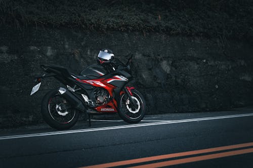 Red and Black Honda Motorcycle Parked on a Roadside
