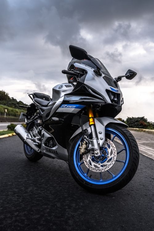 Free High-performance sport bike on asphalt with a stormy sky background, showcasing dynamic design. Stock Photo