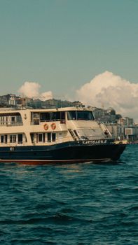 Scenic ferry sailing across the Bosphorus Strait in Istanbul, Turkey, capturing urban skyline.