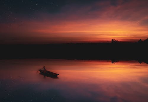 Silhouette of Boat on Body of Water