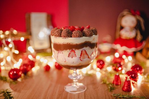 Delicious trifle with layers of chocolate, cream, and fresh strawberries on a festive table.