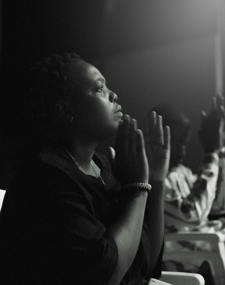 Portrait Of A Man Praying In Black And White