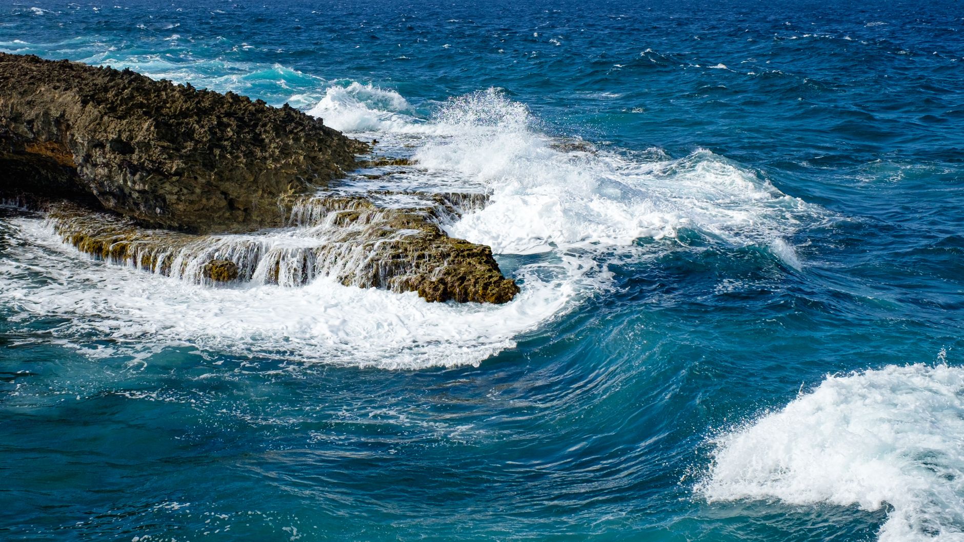 Ocean waves flowing over rocky shoreline