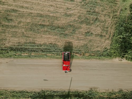 Truck on Dirt Road by Field