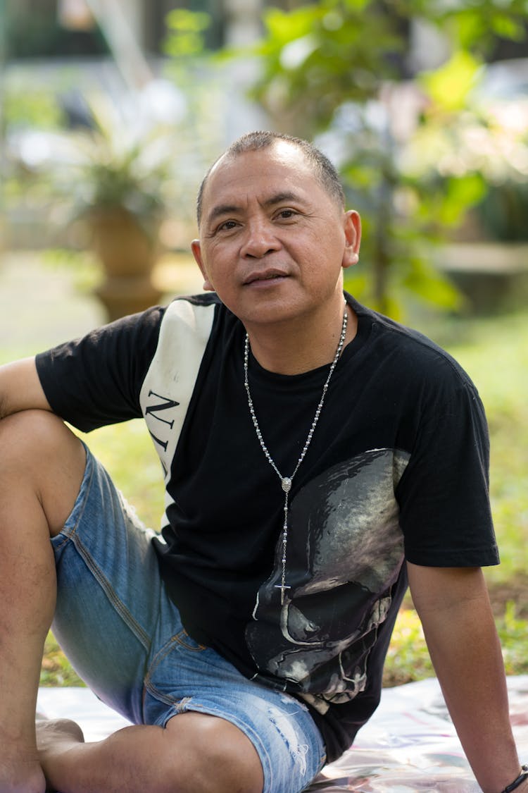 Portrait Of A Man Sitting In A Park