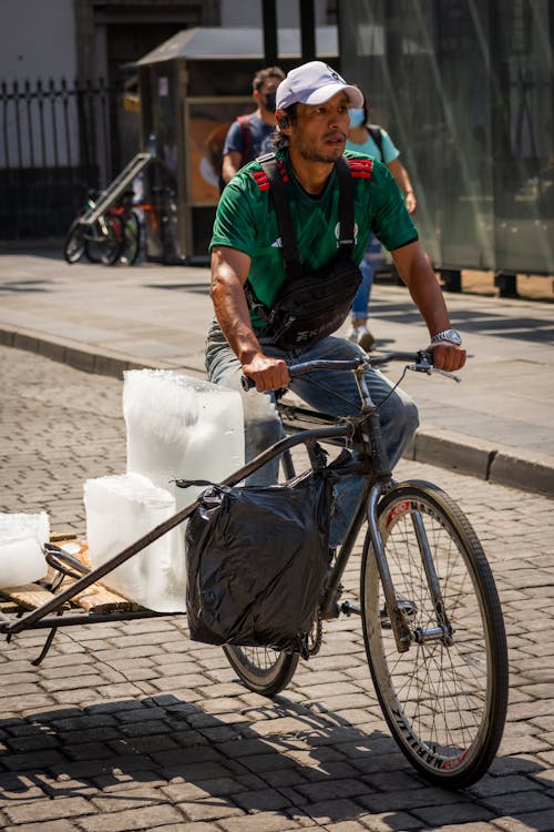 Man Riding on Bike with Blocks of Ice