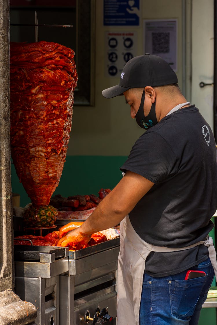 Man Preparing Food On A Street