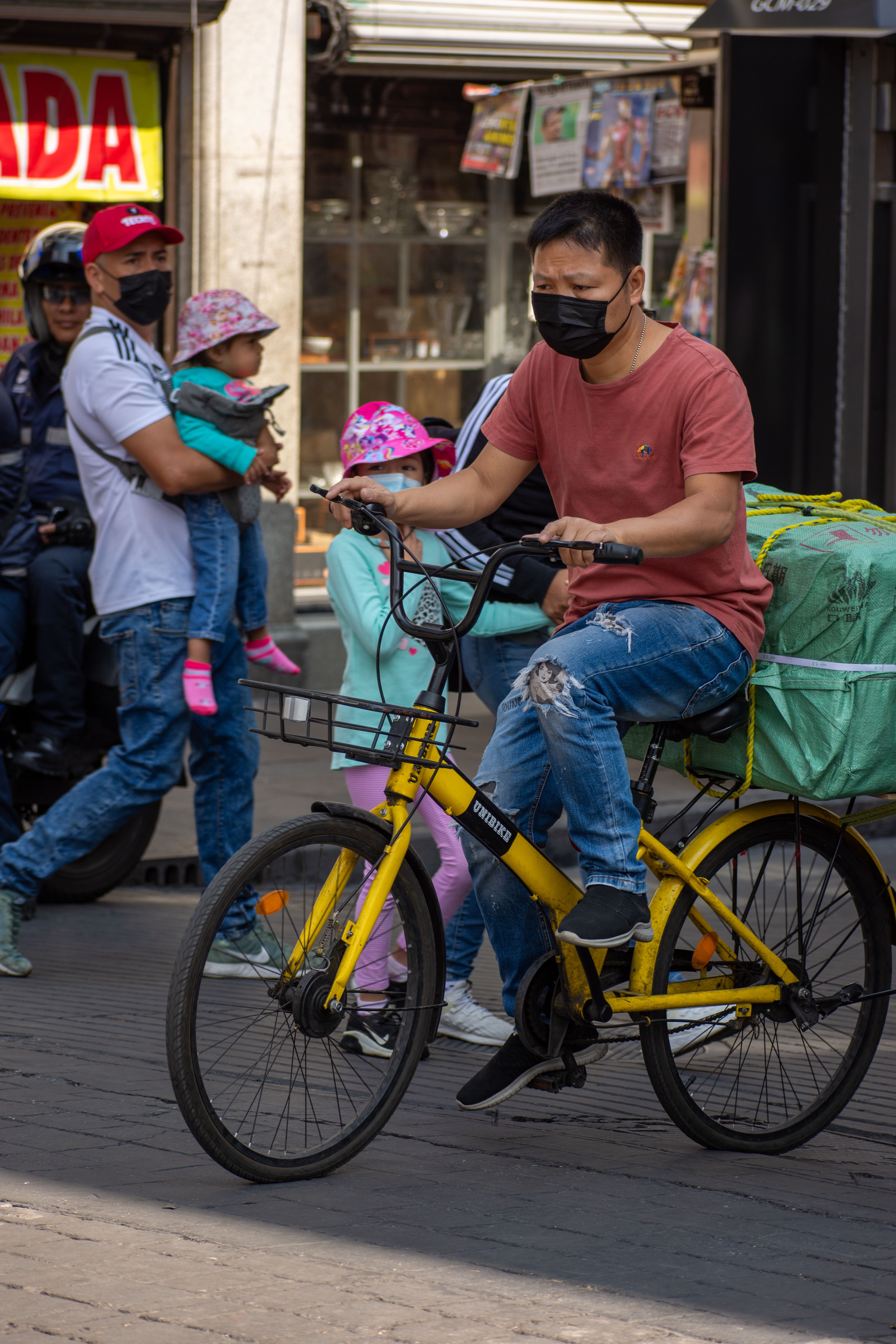 Man in a Face Mask Riding a Bicycle · Free Stock Photo