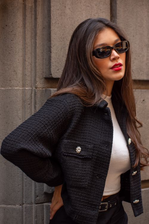 Free Chic young woman in black jacket and sunglasses posing outdoors Stock Photo